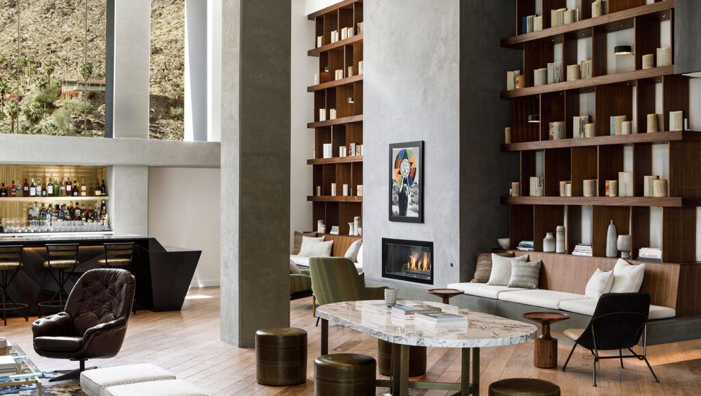 Hotel lounge area and bar with ceiling high shelving and stone pillar