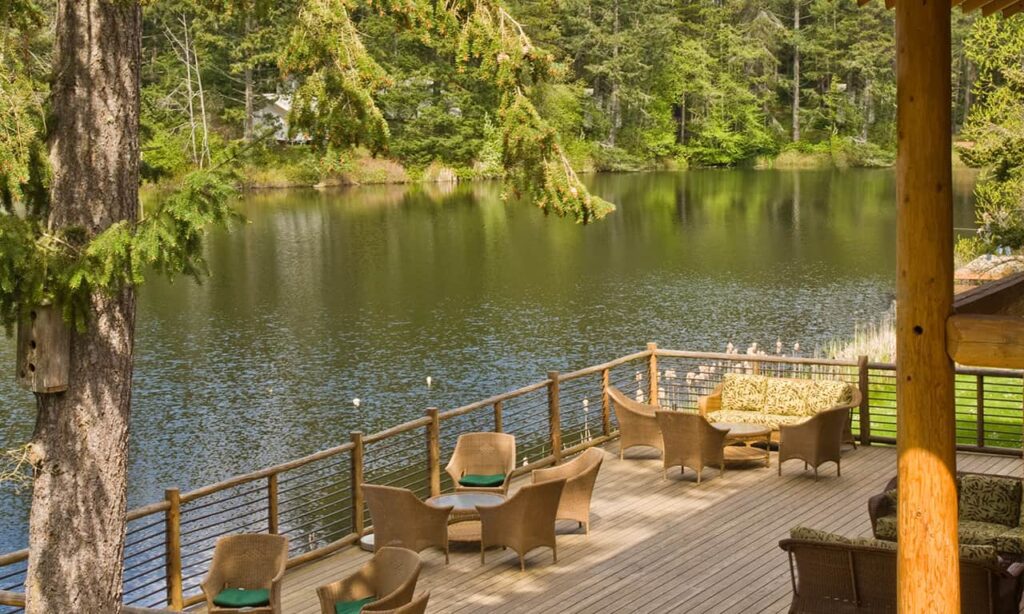 View of wooden deck overlooking a lake