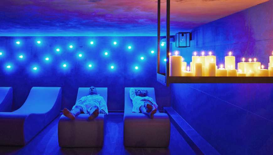 Spa facility with lit candles and blue lights