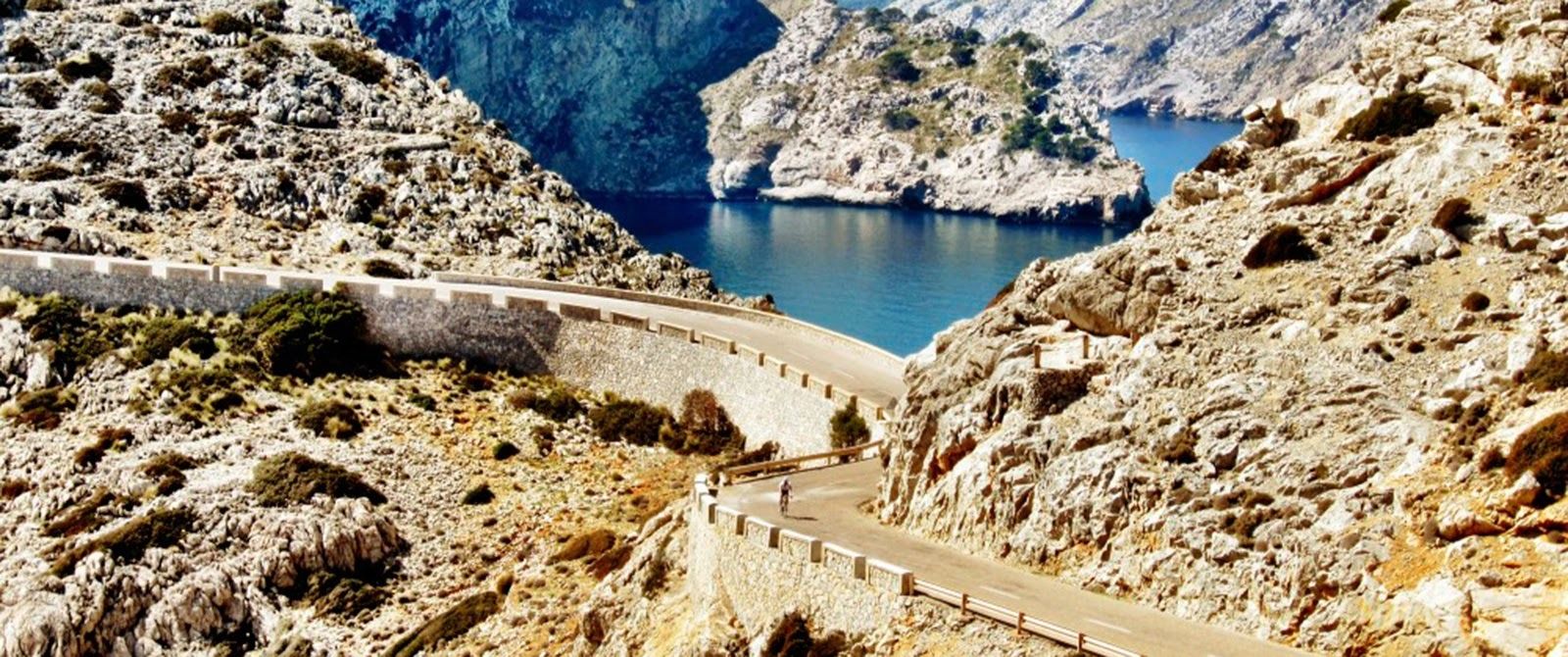 landscape shot with royal blue Mediterranean waters and Mallorcan rocky terrain outlining the photo