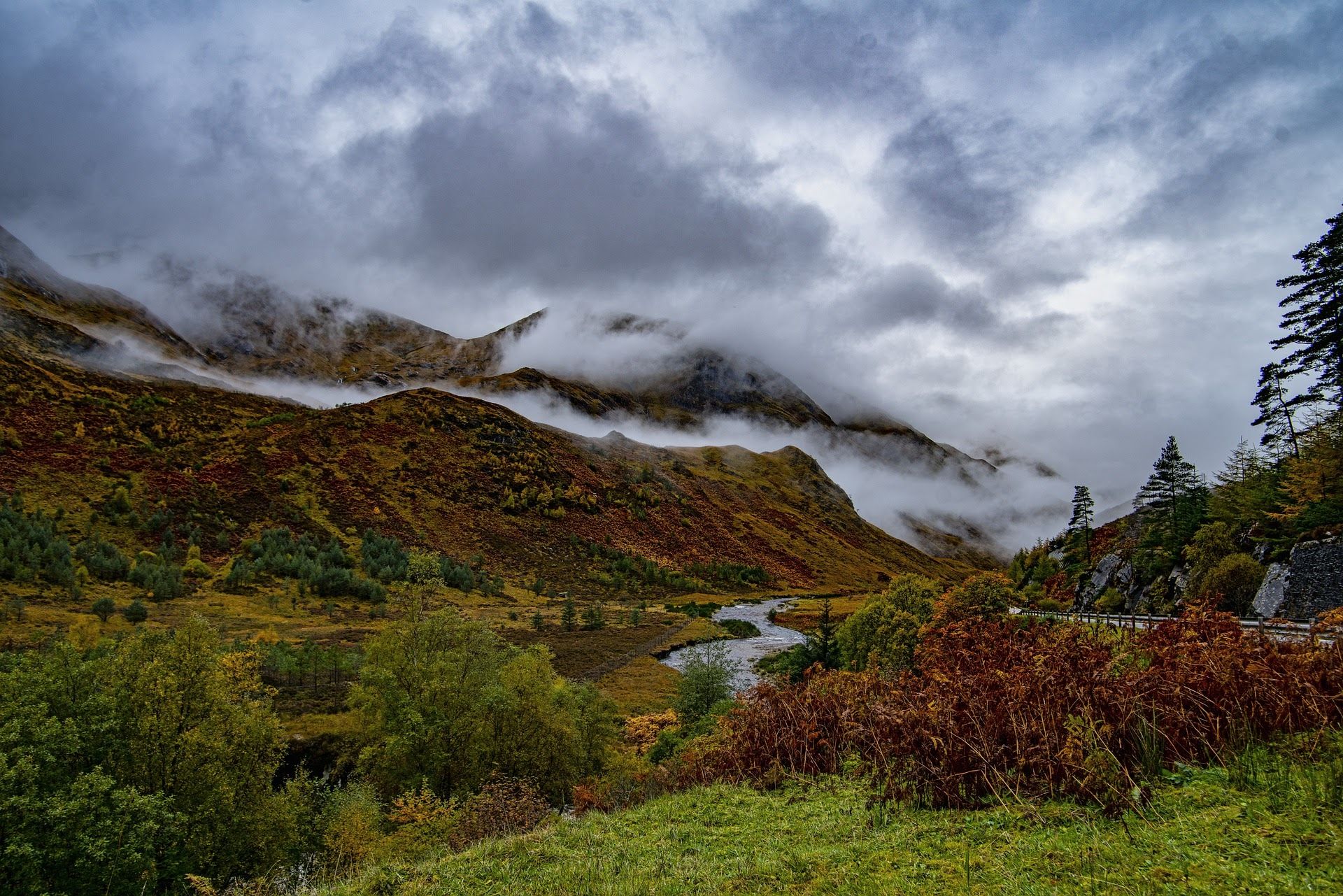 Mist swirls around scottish highland valley