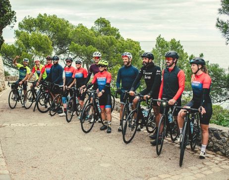 A group of cyclists smiling for the camera in Girona