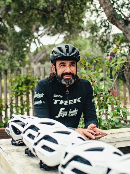 A person standing with their cycling helmet on