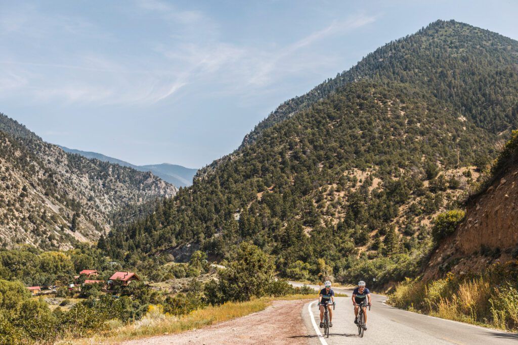 Two people riding their bikes with a mountain view in New Mexico