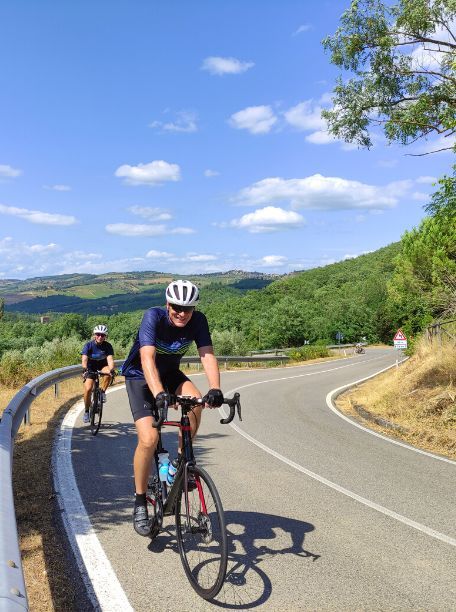 Two Cyclists riding by the camera in Tuscany, Italy