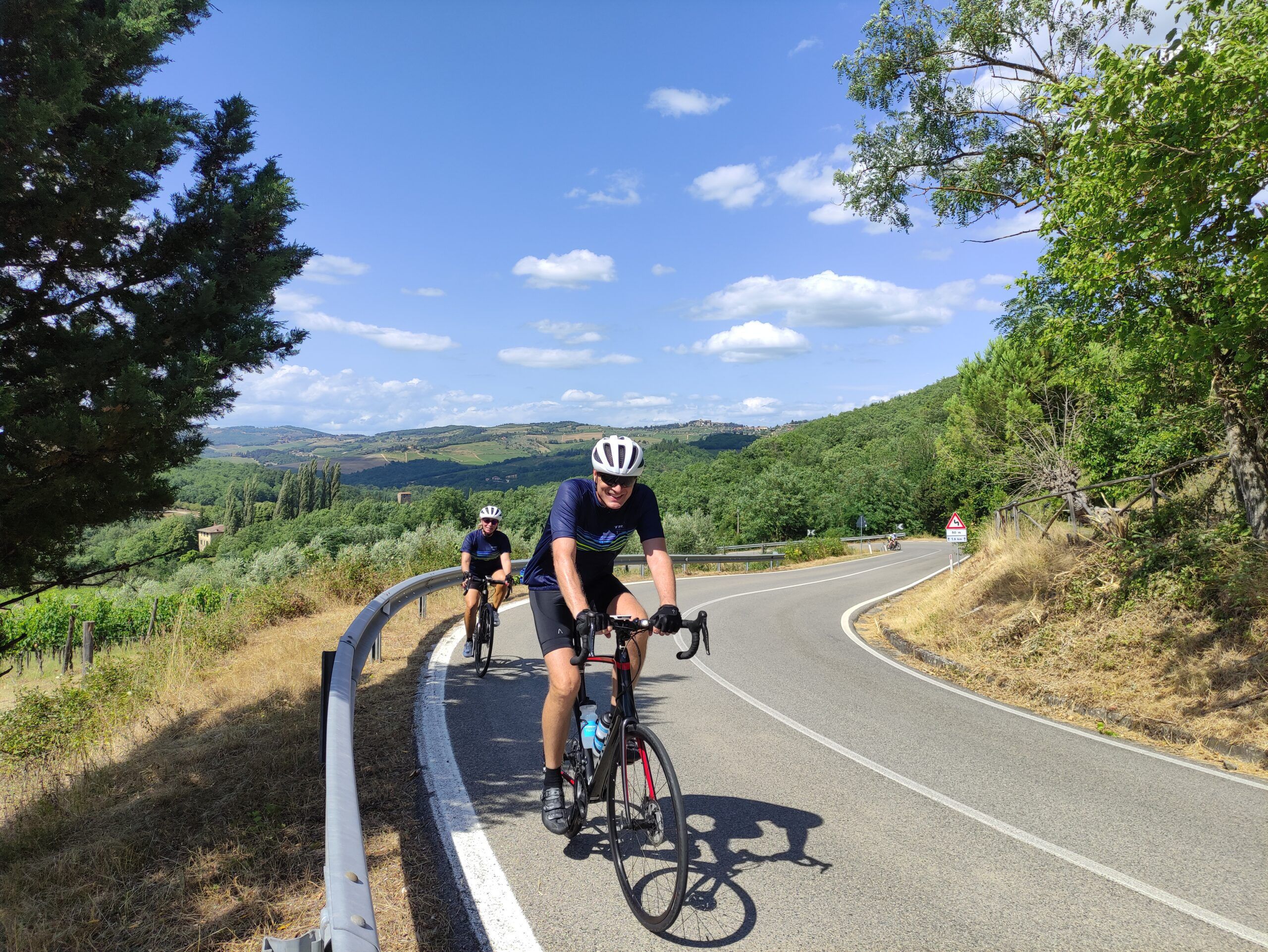 Two Cyclists riding by the camera in Tuscany, Italy