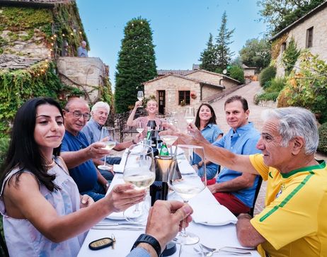 A group toasting at dinner in Tuscany, Italy