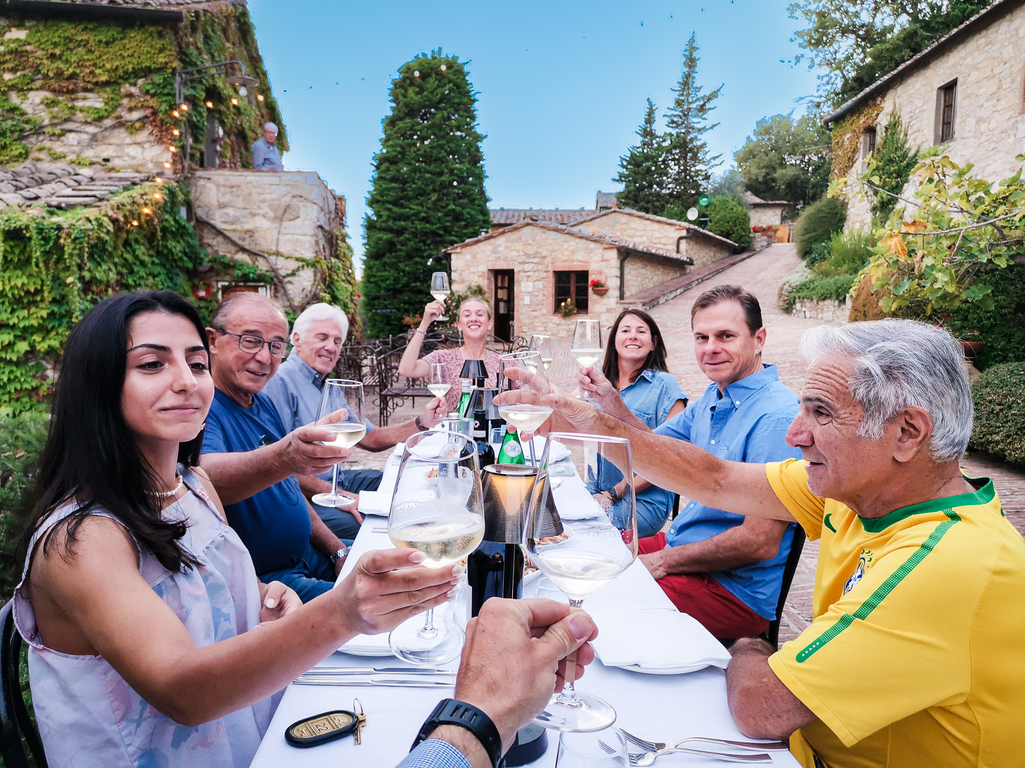 A group toasting at dinner in Tuscany, Italy