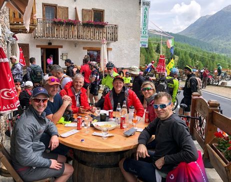 A group of people sitting outside at the Giro d'Italia