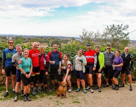 A group of gravel cyclists smiling at the camera in Girona Spain