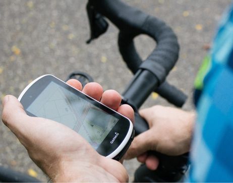 A person using a Garmin cycling computer