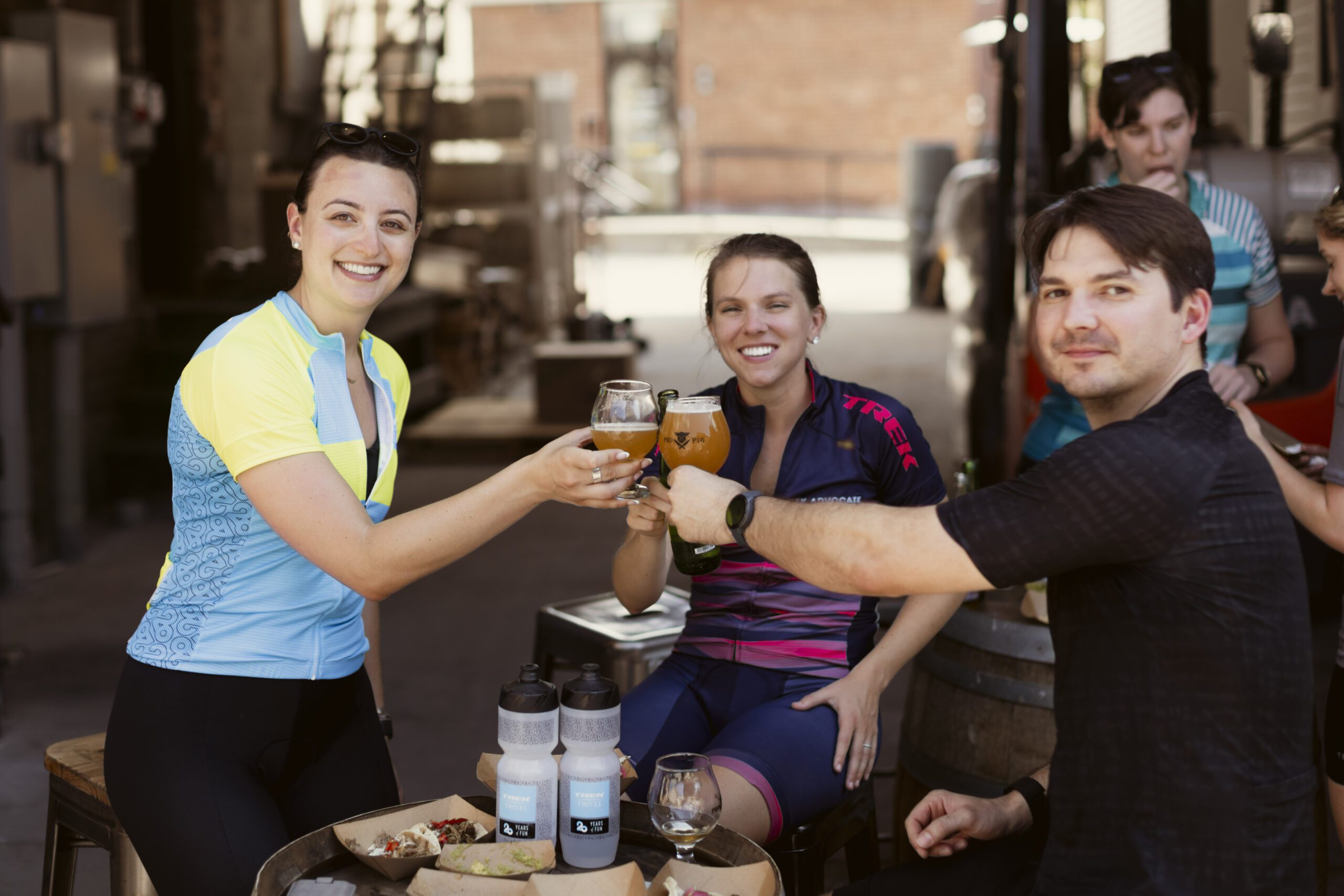 Group of three people enjoying beers.
