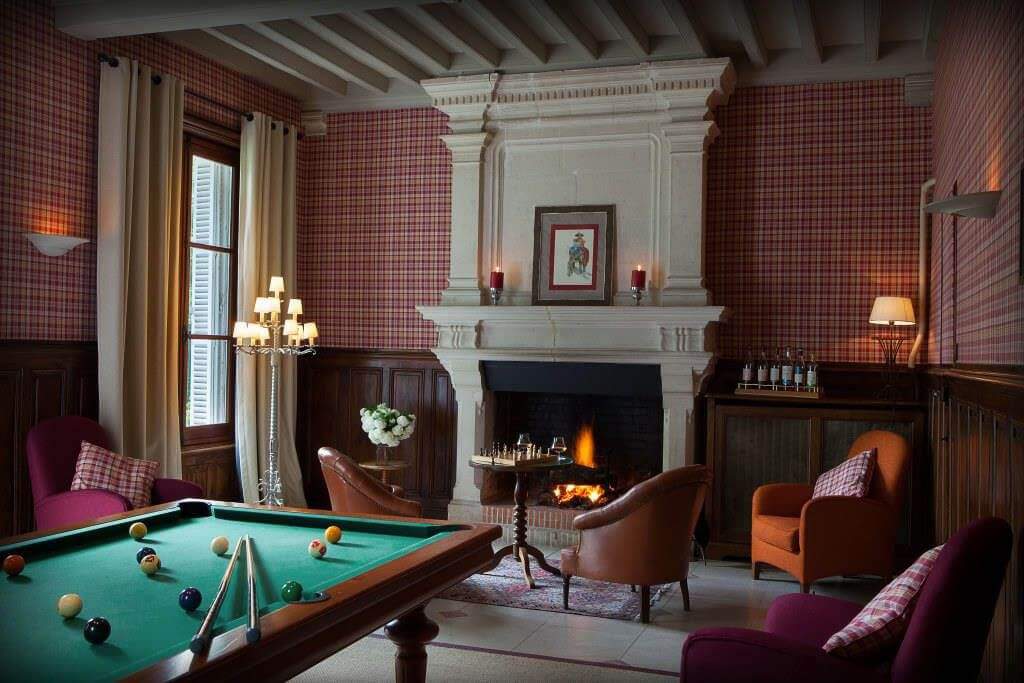Room with billiard table and fireplace