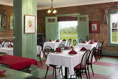 Hotel dining area with exposed brick walls and views to farm outside