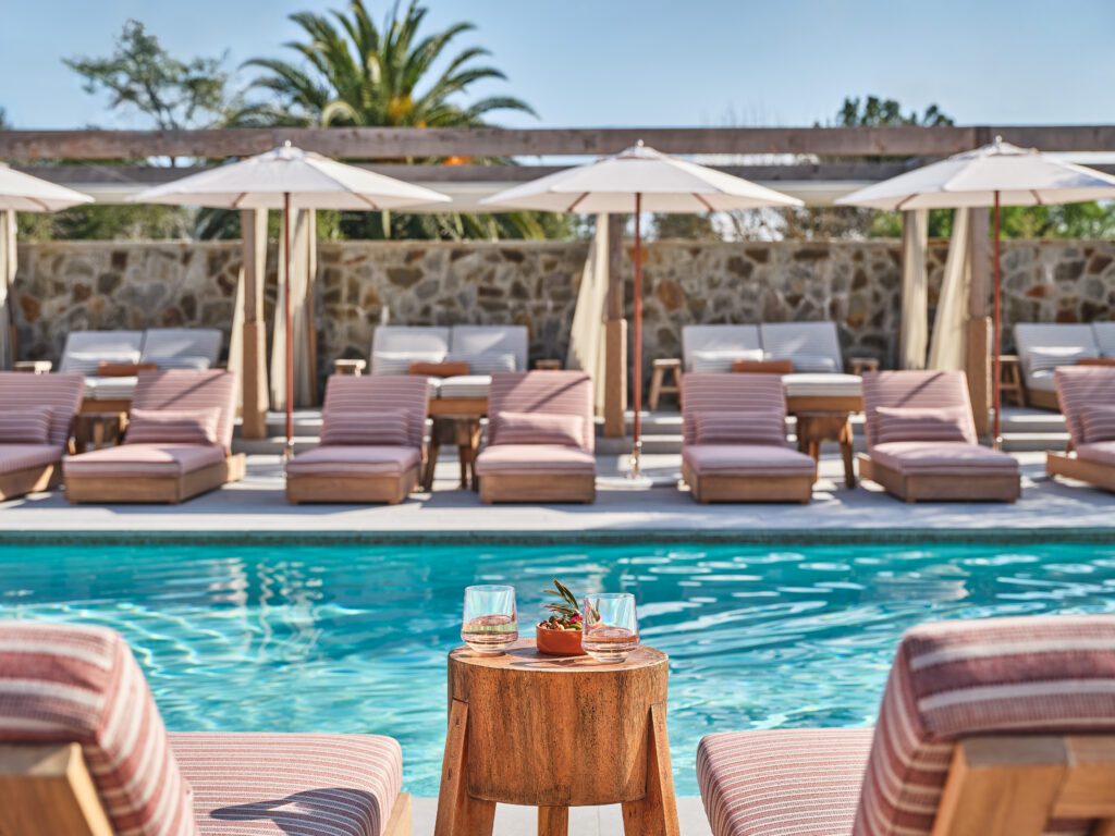 pleasant poolside seating set up with umbrellas and lounge chairs