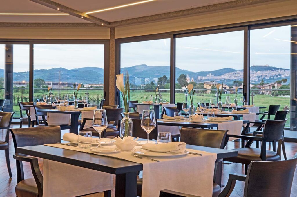 dining area at the Valle di Assisi restaurant with a view of surrounding hills