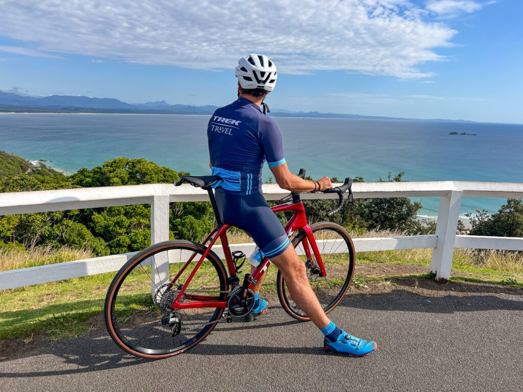 Back of cyclist overlooking the ocean