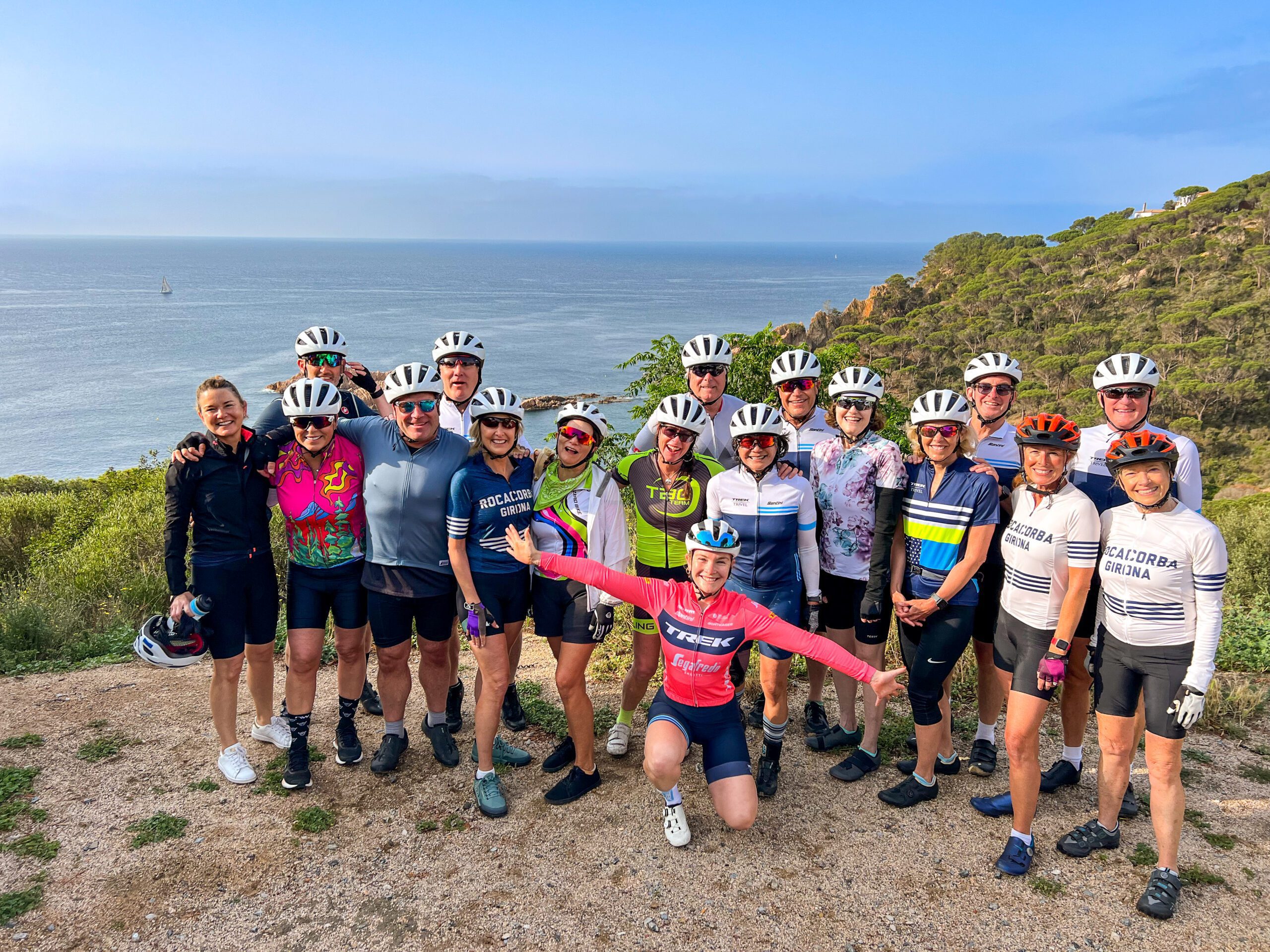A group of people on a bike tour taking a group picture in front of a cliff in Spain