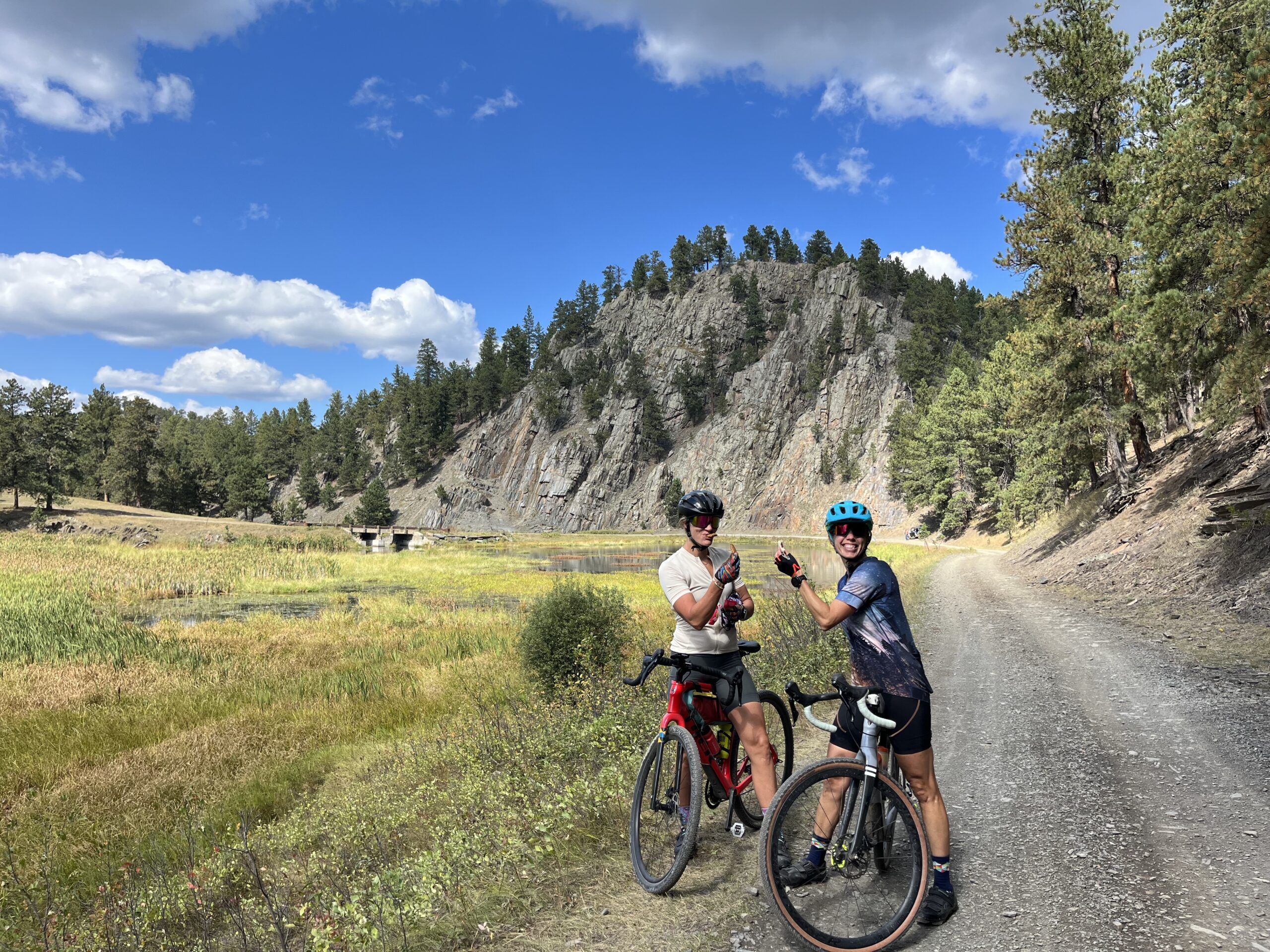 Cyclists having a snack near a pond