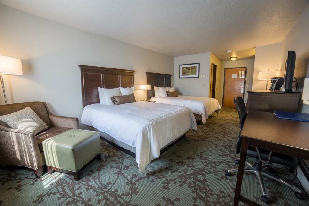 Double bedroom with armchair at Black Hills Lodge