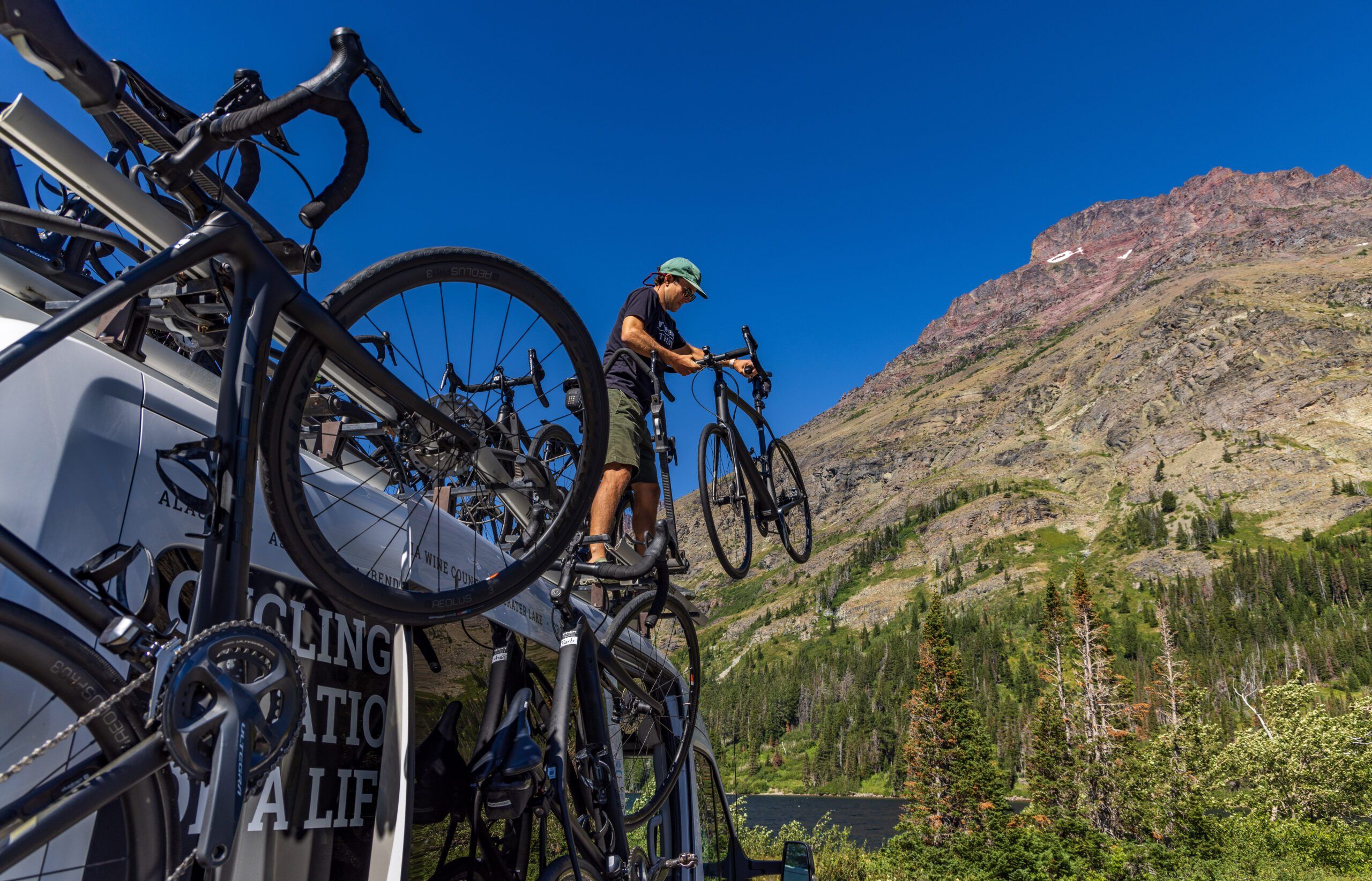 A Trek Travel guide lifting bikes from the Trek Travel van.