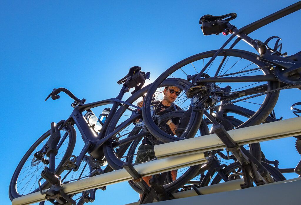 A Trek Travel guide lifting bikes from the Trek Travel van.