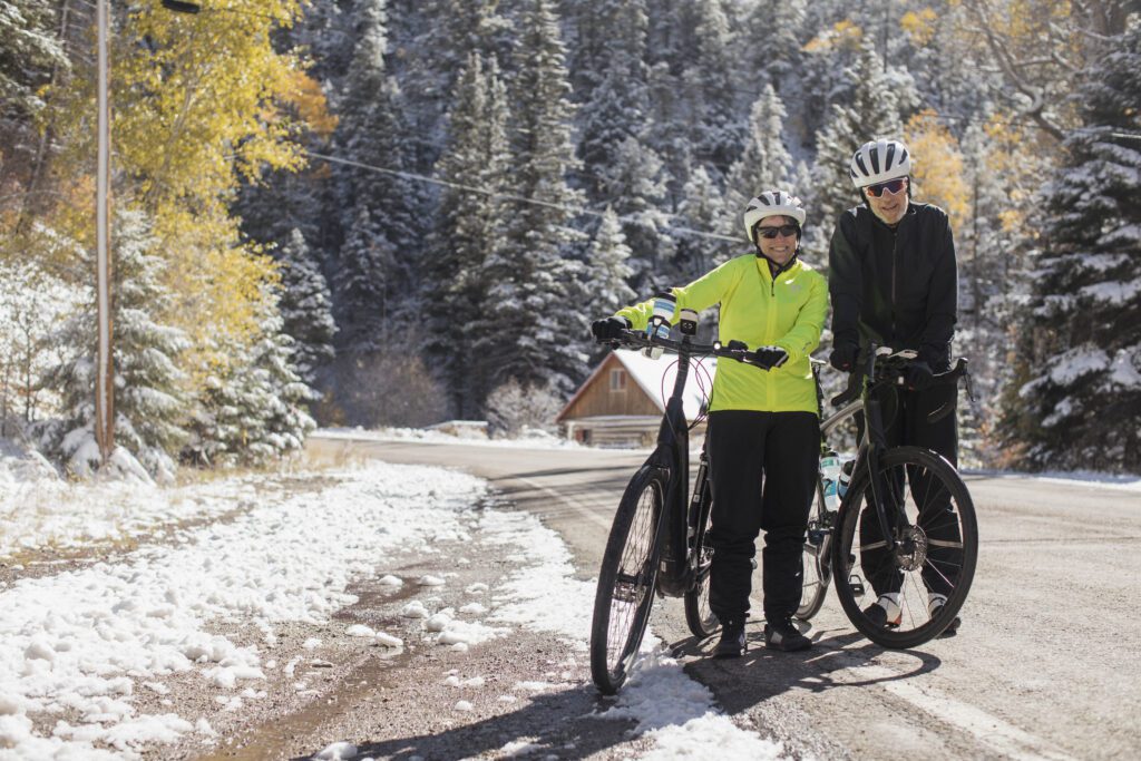 Two cyclists biking in the winter