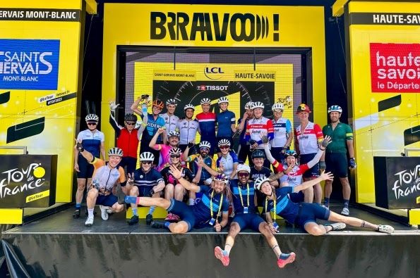 Group posing at the podium of the Tour de France