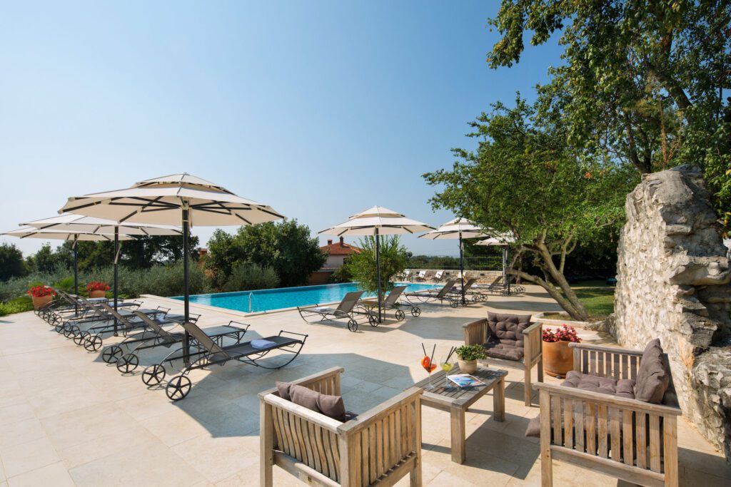 Sunshine on the patio and outdoor pool at Hotel San Rocco