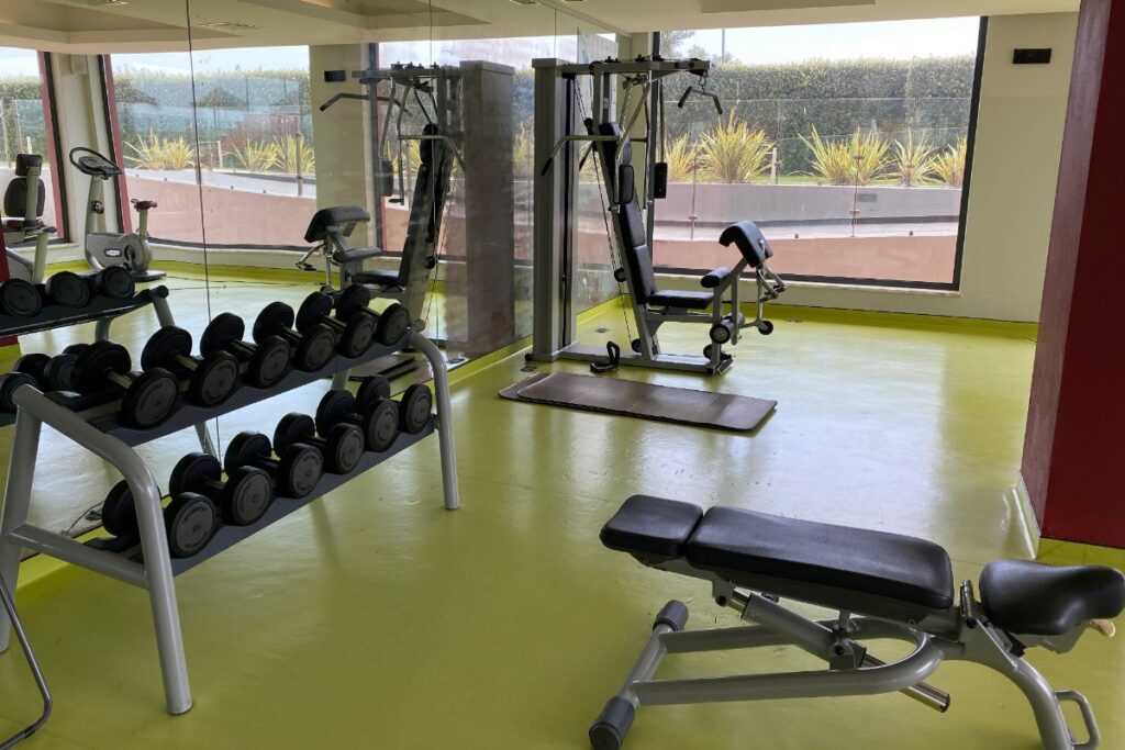 Gym with weights and machines at Agua Hotel and Spa Resort