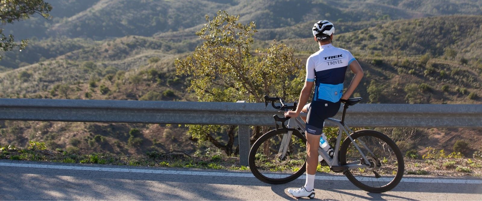 A cyclist overlooking a view of rolling hills