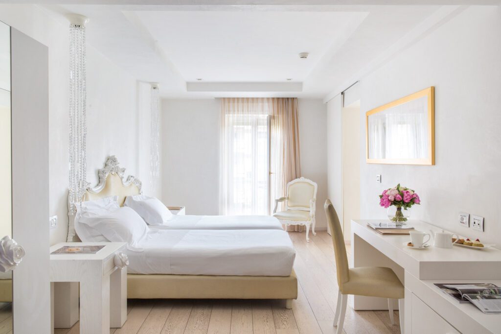 All white and bright twin room at Hotel Boscolo in Nice