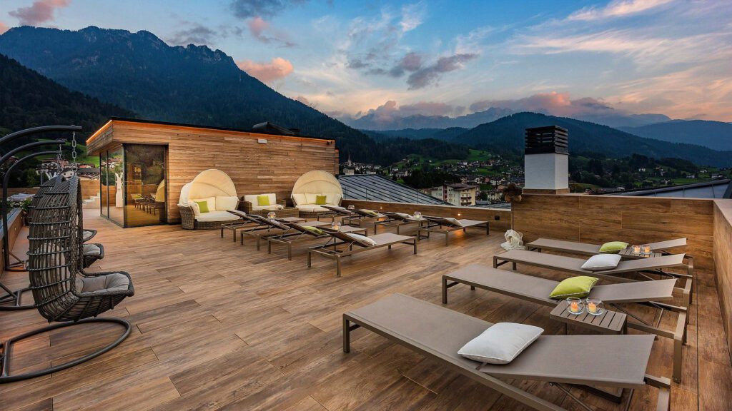 Rooftop patio with lounge chairs at sunset