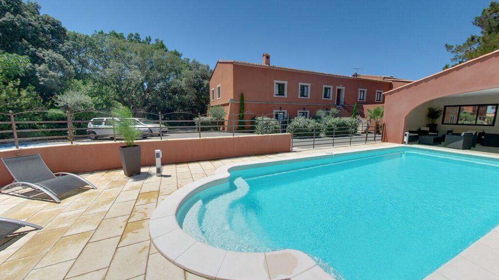 Outdoor pool and lounge area at Hotel du Mas