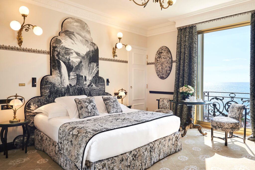 Ornate double hotel bedroom with terrace overlooking the Mediterranean sea