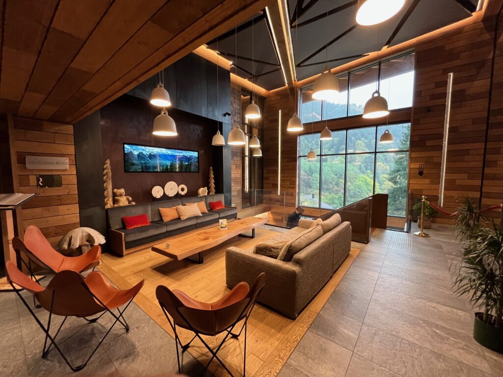 Lounge area with sofas and large windows at Pure Montagne Resort