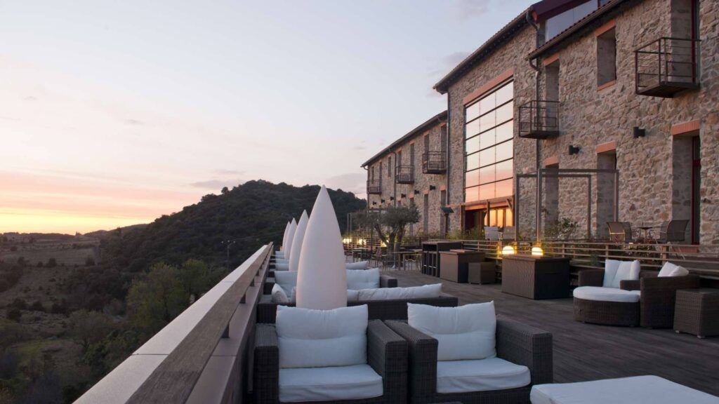 Outdoor patio and bar area with evening vista at Hotel Riberach