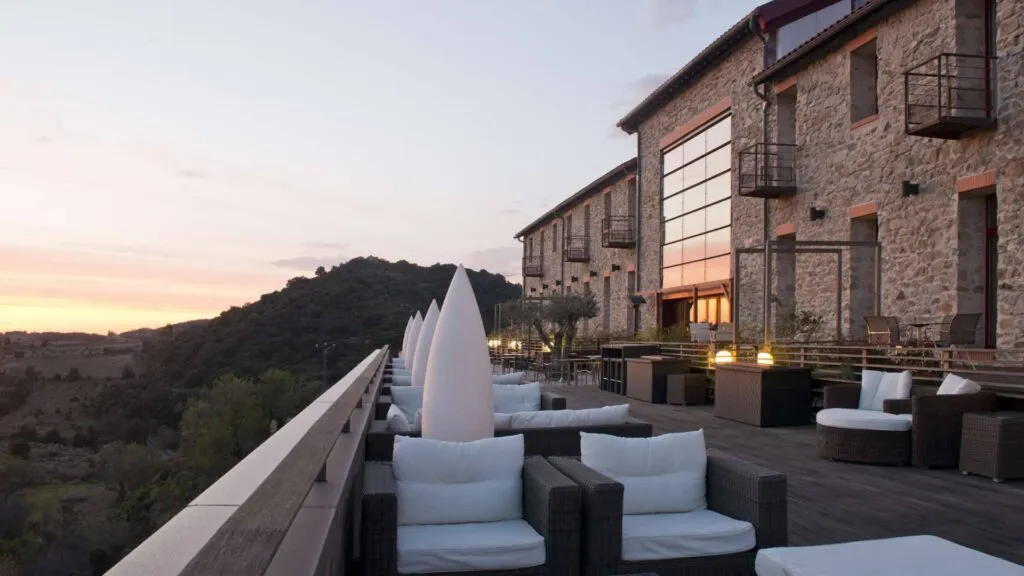 Outdoor patio and bar area with evening vista at Hotel Riberach