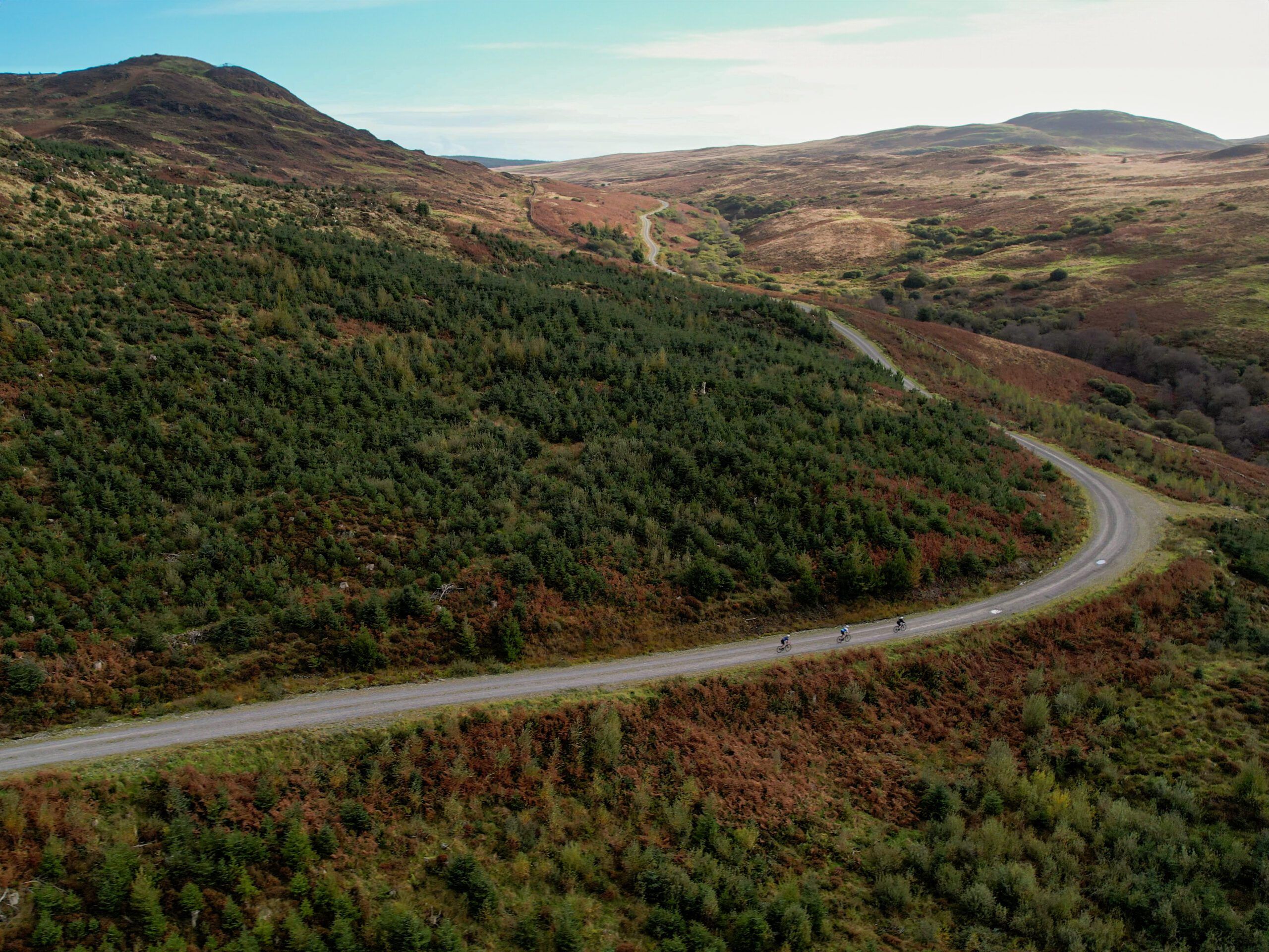 gravel road through forest and hills