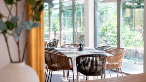 Dining area with glass doors at Zenitude Relais & Spa