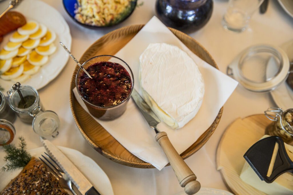 Cheese plates with compote, hard boiled eggs, and other food plates