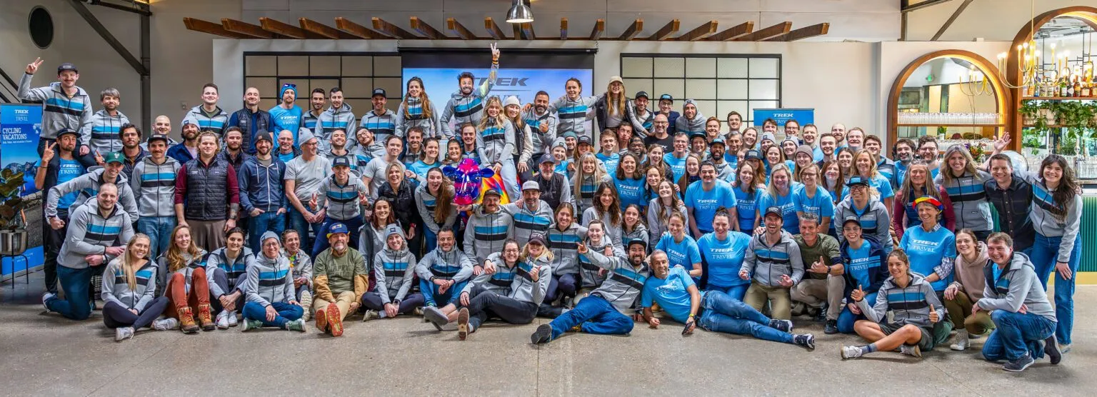A large group of Trek Travel guides smiling at the camera.