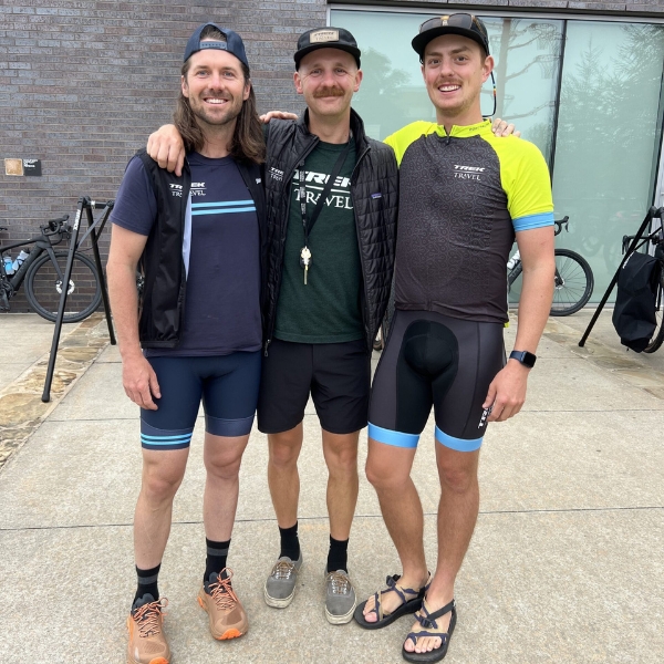 three smiling guides in cycling gear