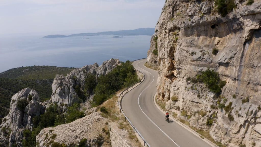 A cyclist riding their bike to the coast in Croatia