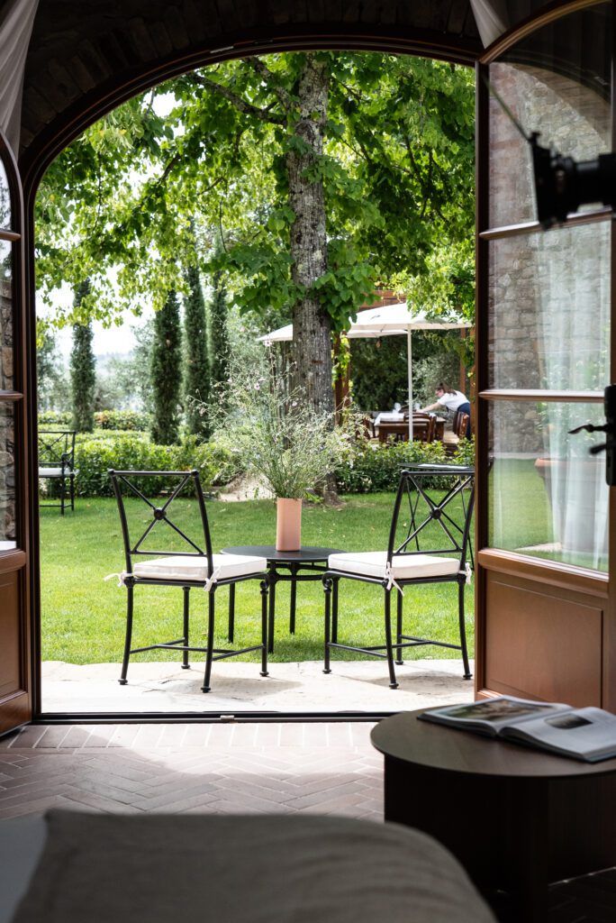 View of patio outside from inside a bedroom with arched entrance